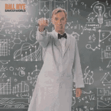 a man in a lab coat and bow tie is standing in front of a blackboard holding a pen .