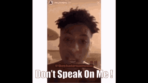 a man with dreadlocks says " don 't speak on me " in front of his face