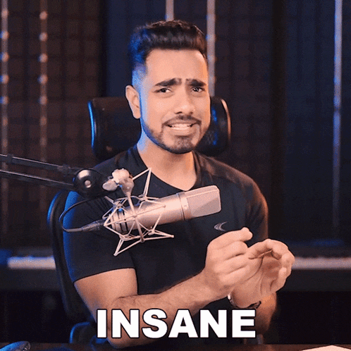 a man sitting in front of a microphone with the word insane written on the bottom