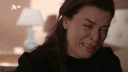 a woman is crying with a tear coming out of her eye and a hd logo behind her