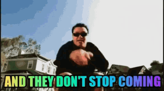 a man wearing sunglasses stands in front of a sign that says and they don t stop coming