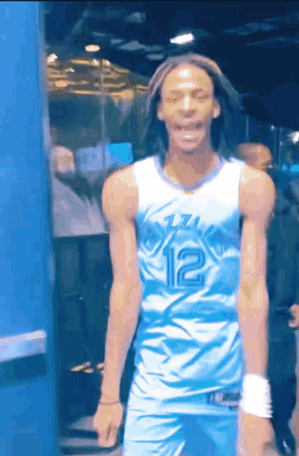 a man wearing a blue and white jersey with the number 12 on it