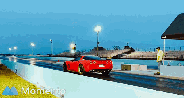 a red sports car is driving down a race track with the words momento behind it