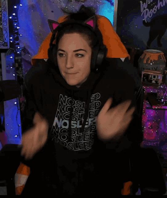 a woman wearing headphones and a black shirt that says sleep