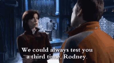a man and a woman are standing next to each other and rodney is talking to them