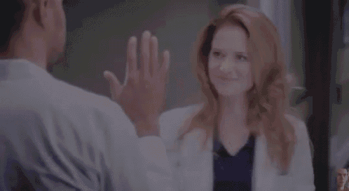 a man and a woman are standing next to each other in a hospital room .