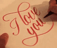 a person is writing on a piece of paper with a marker .
