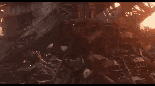 a man is standing in front of a pile of rocks with a fireball coming out of his hand .