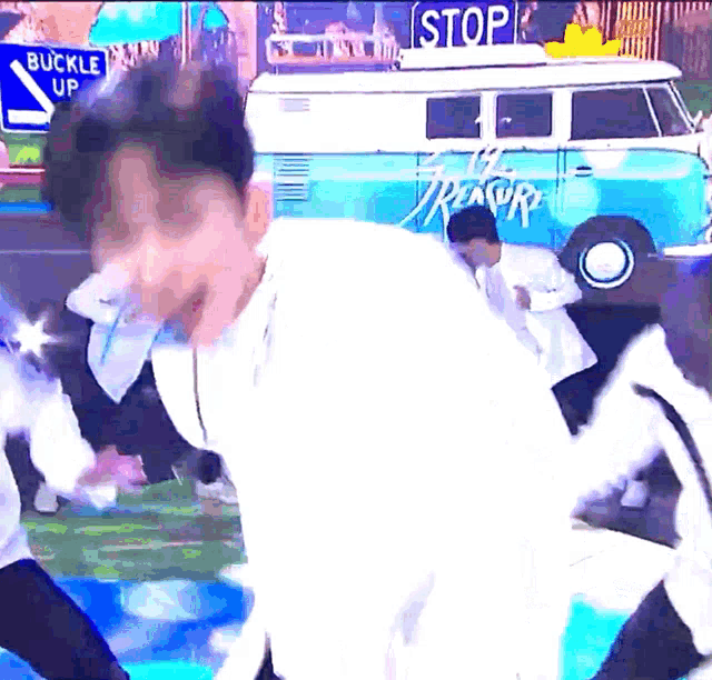 a man is dancing in front of a bus that says stop