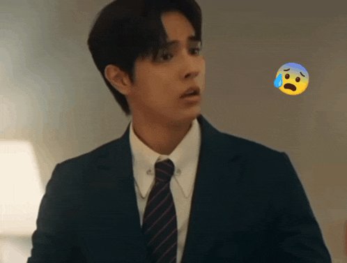 a man in a suit and tie with a sad face