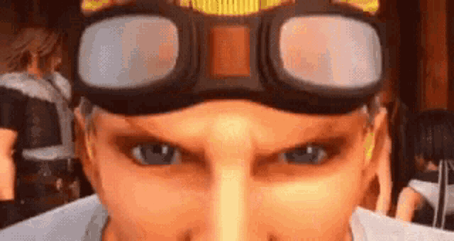 a close up of a man 's face wearing goggles and looking at the camera .