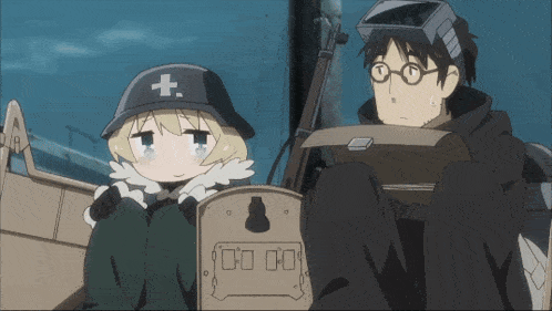 a girl with a cross on her hat is sitting next to a man with glasses