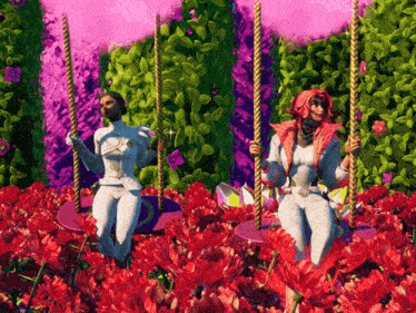 two women are swinging in a field of red flowers
