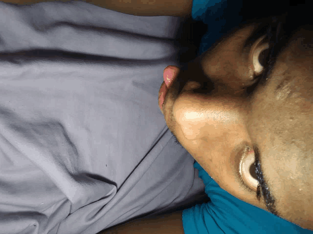 a close up of a man 's face with his tongue out