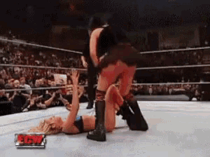 two women wrestling in a ring with a sign that says rsw
