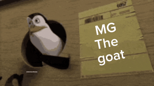 a penguin is standing next to a piece of paper that says " mg the goat "