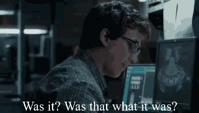 a man wearing glasses is sitting in front of a computer screen and asking was it ? was that what it was ?