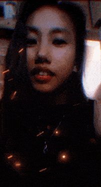 a close up of a woman 's face with a glowing circle in her mouth