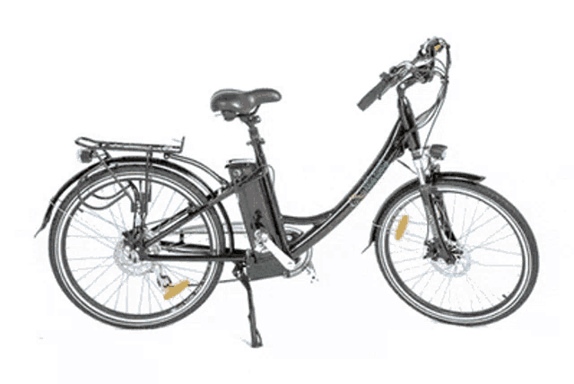 a black folding electric bike with kenda tires is parked on the beach