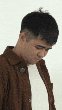 a man wearing a brown jacket and a white shirt