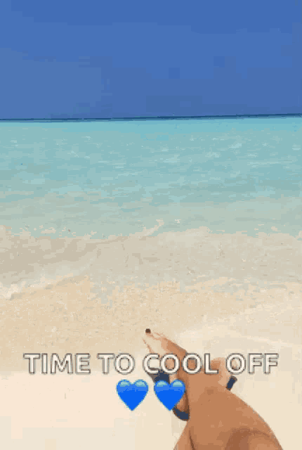 a person laying on a beach with the words " time to cool off "