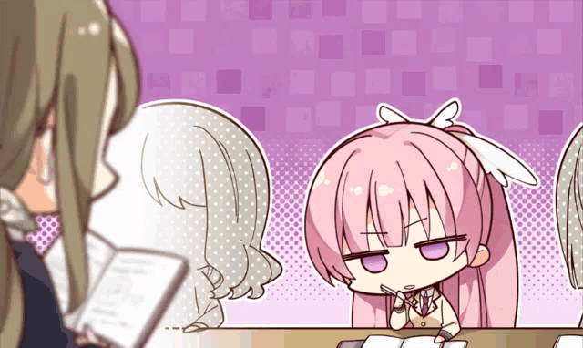 a girl with pink hair is sitting at a desk with other girls