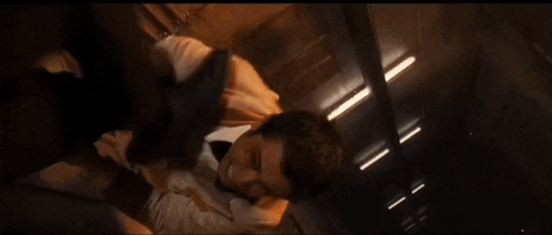 a man in a tuxedo and bow tie is flying through the air