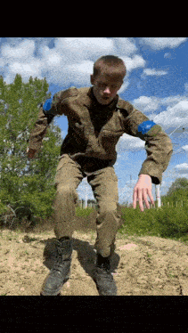 a young man in a military uniform is jumping in the air