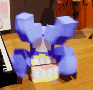 a blue cube is sitting on a wooden floor in front of a piano