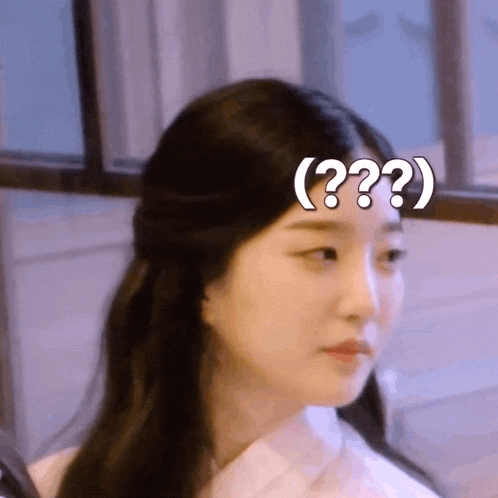 a woman with a question mark on her forehead is making a funny face .