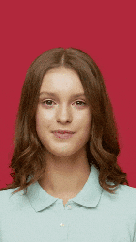a woman in a blue shirt is making a face