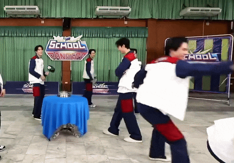 a group of people standing around a table with a sign that says school rangers on it