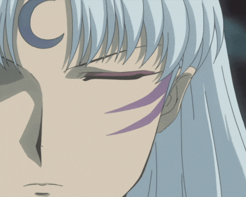 a close up of a person 's face with a crescent moon on their head
