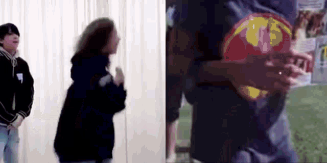 a man and a woman are standing next to each other in a room . the man is wearing a superman shirt .