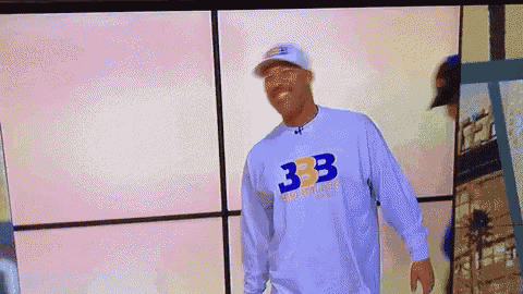 a man wearing a white shirt that says 333 on it