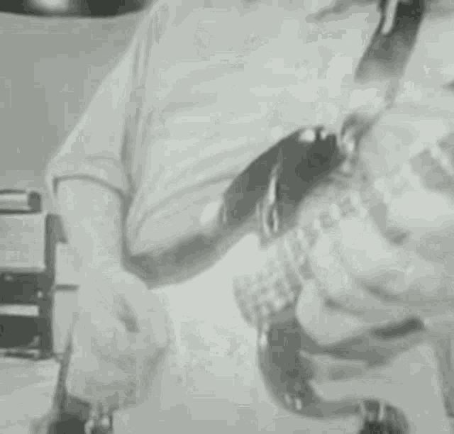 a man is playing an electric guitar in a black and white photo .