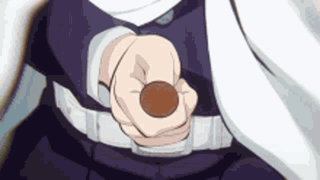 a person is holding a brown coin in their hand .