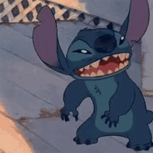 stitch from disney 's lilo and stitch is standing on a wooden floor with his mouth open and teeth showing .