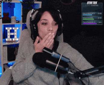 a woman wearing headphones and a microphone playing star trek