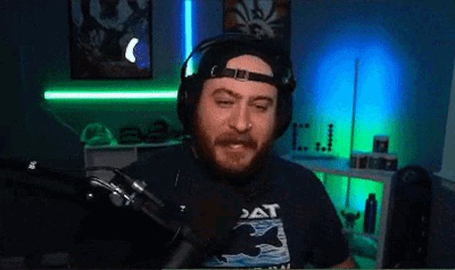 a man wearing headphones and a shirt that says dat
