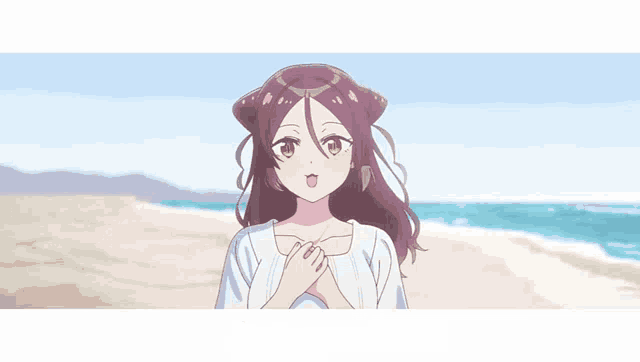 a girl is standing on a beach with her hands on her chest and looking at the camera .