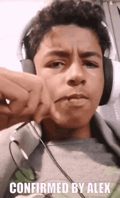 a young man wearing headphones with the caption confirmed by alex on the bottom