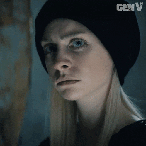 a close up of a woman wearing a black hat with genv written on it
