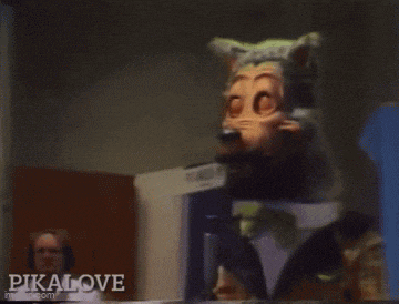 a man in a white shirt stands in front of a mascot with pikalove written on the bottom