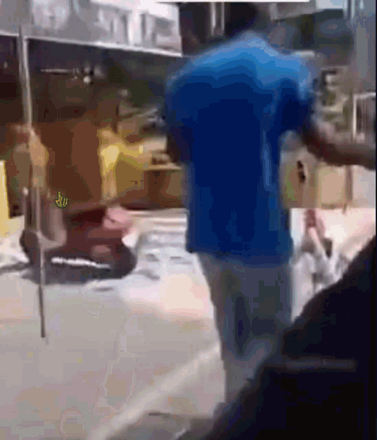 a blurry picture of a man in a blue shirt standing on a street