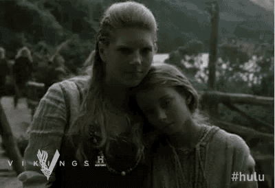 a woman and a child are standing next to each other and hugging .
