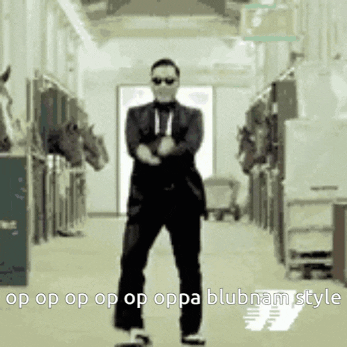 a man in a suit is dancing in a hallway with horses behind him