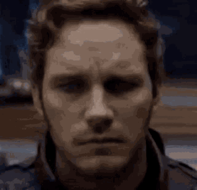 a close up of a man 's face with the word guh on his face .