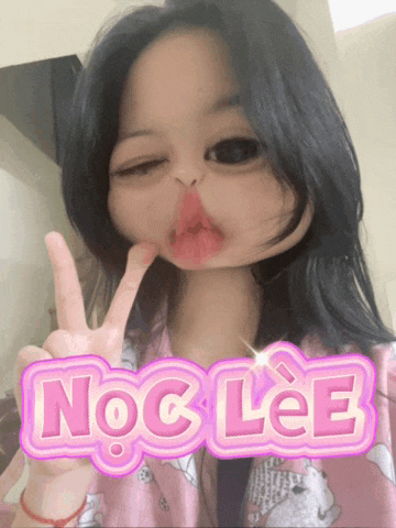 a girl giving a peace sign with the word noc lee in the background