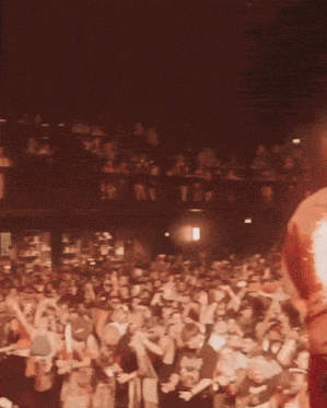a man in a red shirt with a flower on it